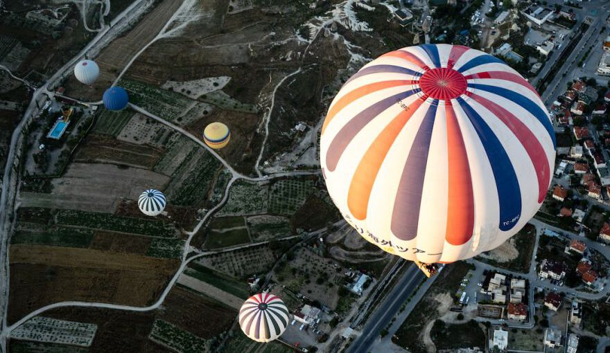 Authentic Local Hospitality Cappadocia - white and blue hot air balloon floating on city