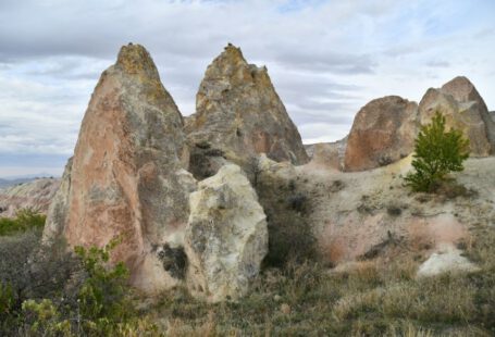Cappadocia Timeline Settlement - a group of large rocks sitting in the middle of a field