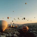 Local Celebrations Cappadocia - hot air balloons flying over the field during daytime