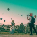 Sustainable Travel Cappadocia - man taking photo of hot air balloons