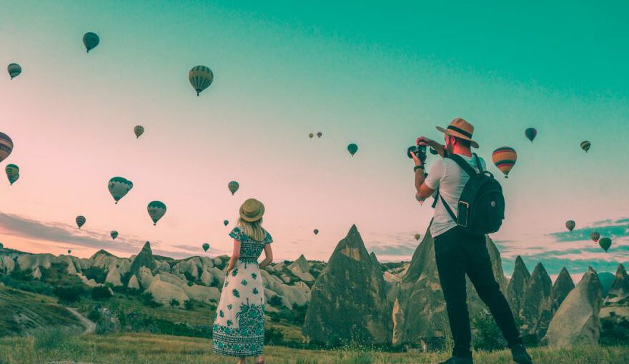 Sustainable Travel Cappadocia - man taking photo of hot air balloons