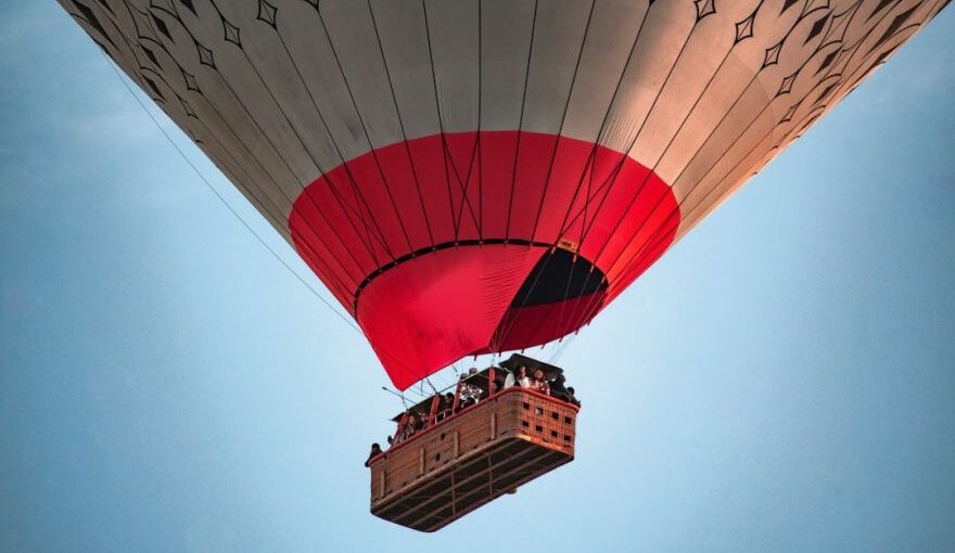 Cappadocia Hot Air Adventure - a large hot air balloon flying through a blue sky