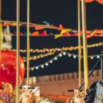 Traditional Entertainment Cappadocia - Festive merry go round with carnival horses on Red Square against blurred Kremlin during New Year holidays in evening