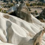 Scenic Hikes Cappadocia - Scenery view of massive rocky formation with smooth curvy slopes located on highlands with many rough volcanic peaks in Cappadocia