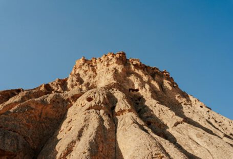 Explore Cappadocia Cappadocia - a rocky mountain with a blue sky