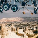 Cultural Etiquette Cappadocia - Amulets made of blue glass reminding eye hanging on tree branches in Cappadocia