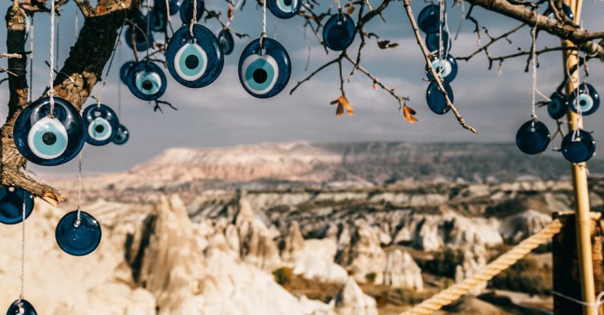 Cultural Etiquette Cappadocia - Amulets made of blue glass reminding eye hanging on tree branches in Cappadocia
