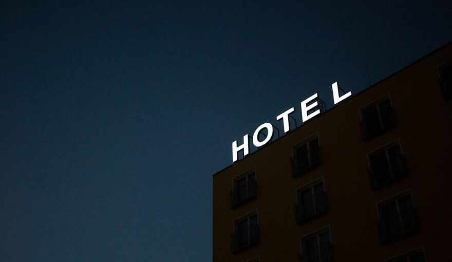Cave Hotel Selection Cappadocia - low-angle photo of Hotel lighted signage on top of brown building during nighttime