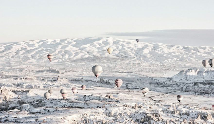 Family Travel Cappadocia - assorted-color air balloons below snowland at daytime