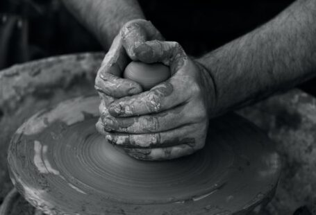 Avanos Turkish Pottery Workshop - grayscale photography of person's hand making pot