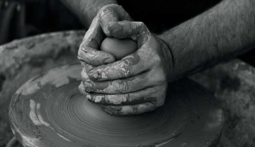 Avanos Turkish Pottery Workshop - grayscale photography of person's hand making pot
