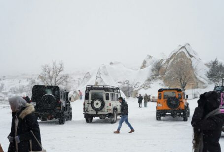 Cappadocia Winter Adventure - a group of people walking in the snow next to a group of vehicles