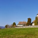 Mustafapasa Historic Village - brown and white concrete house near green grass field under blue sky during daytime