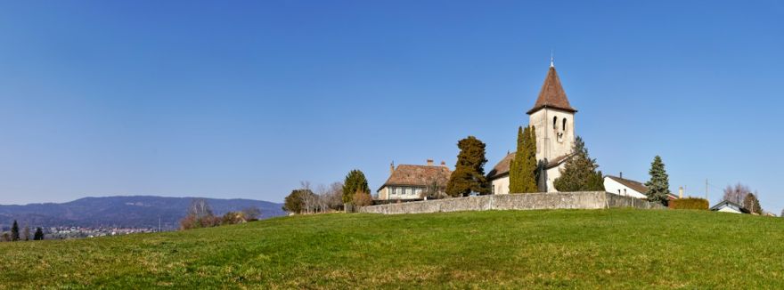 Mustafapasa Historic Village - brown and white concrete house near green grass field under blue sky during daytime