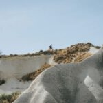Hiking In Cappadocia - a person standing on a hill