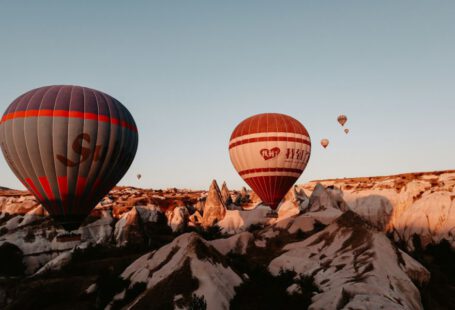 Photography Contest Cappadocia - red and black hot air balloon flying over the mountain