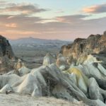 Cappadocia Sunset Views - a group of rocks in the middle of a desert