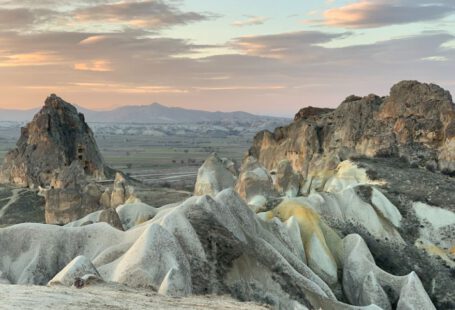 Cappadocia Sunset Views - a group of rocks in the middle of a desert