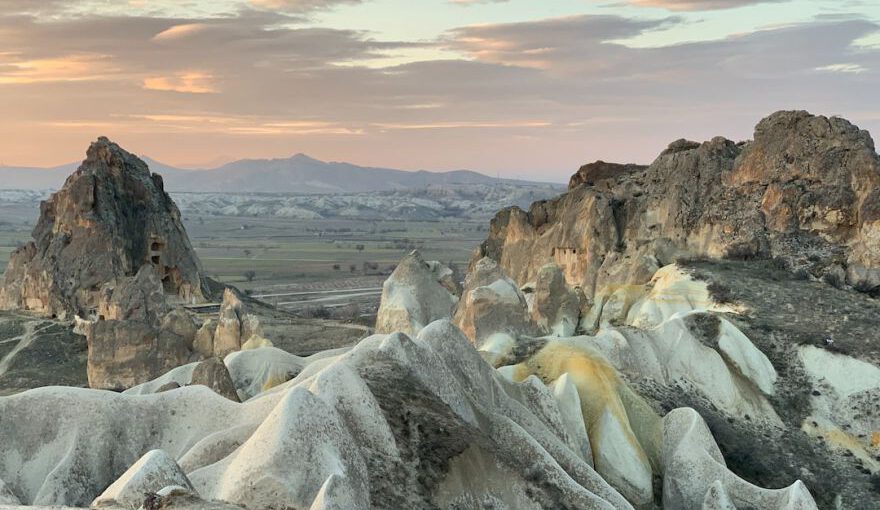 Cappadocia Sunset Views - a group of rocks in the middle of a desert