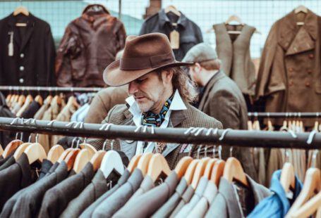 Charming Shopping Ürgüp - man in brown cowboy hat in front of hanged suit jackets