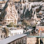 Popularly Reviewed Accommodations Cappadocia - View from arched doorway on medieval Goreme town in Cappadocia among rocky cliffs
