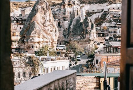Popularly Reviewed Accommodations Cappadocia - View from arched doorway on medieval Goreme town in Cappadocia among rocky cliffs