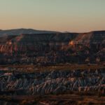 Cappadocia Chimneys - brown rocky mountain under gray sky during daytime