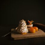 Dessert - two red tomatoes on brown wooden mat