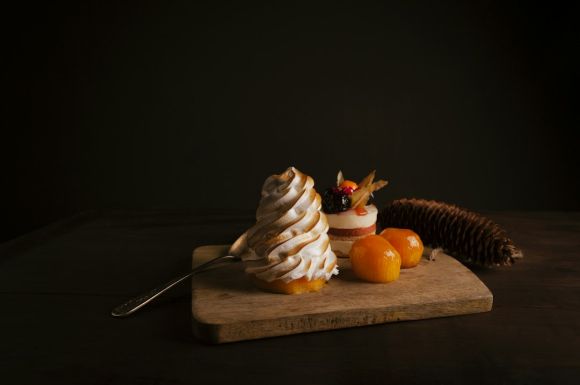 Dessert - two red tomatoes on brown wooden mat