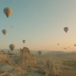 Göreme - a bunch of hot air balloons flying in the sky