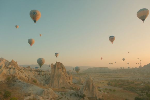 Göreme - a bunch of hot air balloons flying in the sky