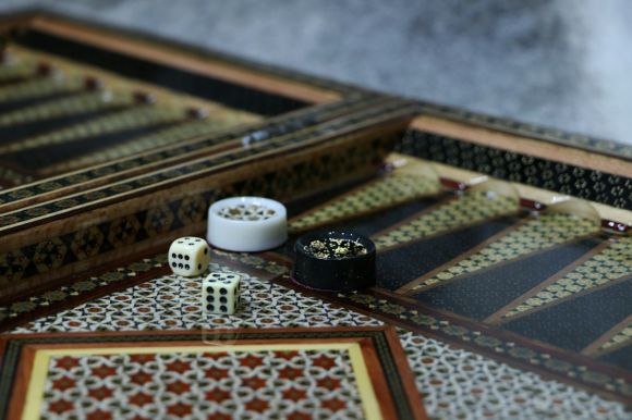 Backgammon - white and black ceramic mug on brown and white rug