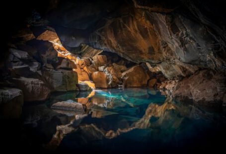 Cave Suites - cave surrounded with blue body of water