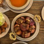 Aerial view of a traditional Turkish meal setup with soup, kebab, and salad.